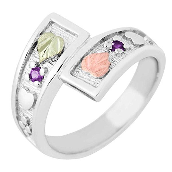 Black Hills Gold on sterling silver with raised hearts on an ice finished back ground; this synthetic Amethyst February birthstone bypass ring has two leaves.
